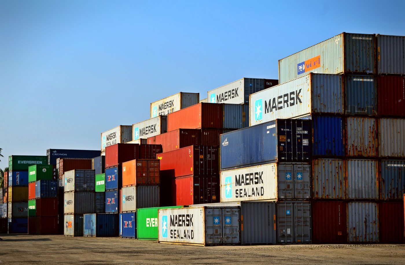 Refrigerated freight truck positioned near shipping containers